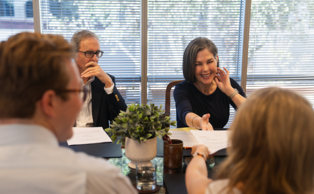 Donahoo attorneys conversing around a table